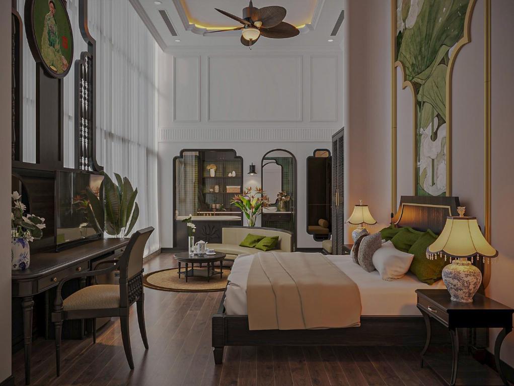 a bedroom with a bed and a desk and a piano at Khách sạn Solis Hotel in Hai Phong