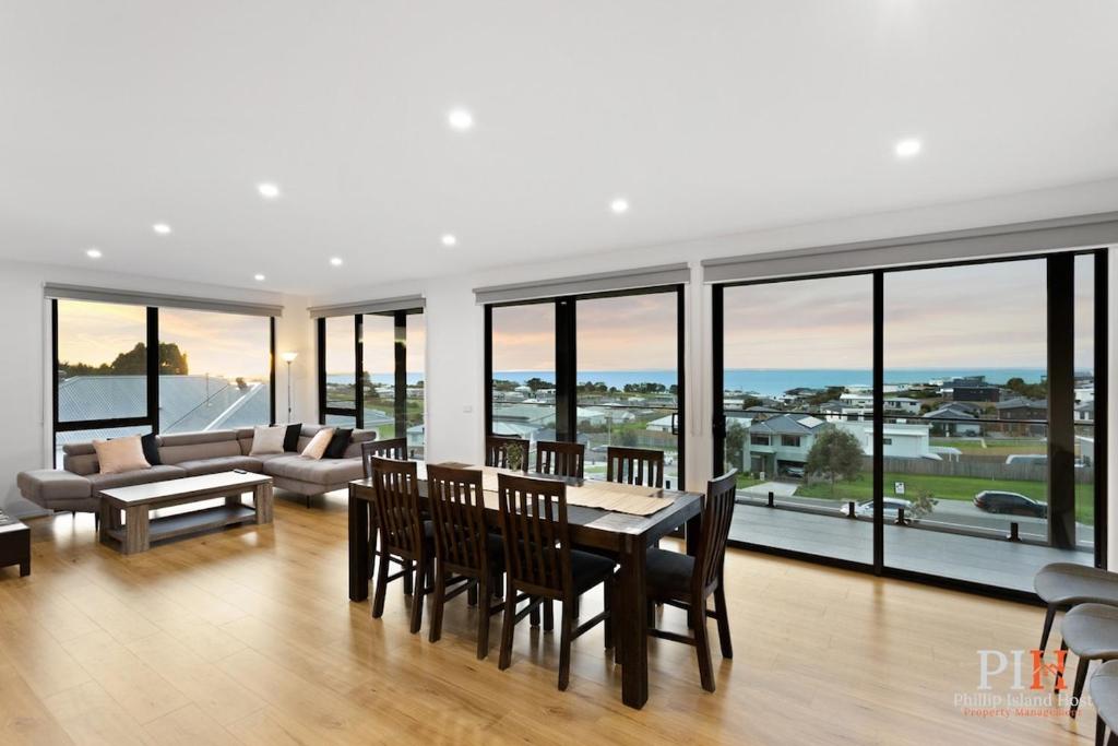 a large living room with a table and chairs at Panoramic Paradise 4-BR San Remo in San Remo