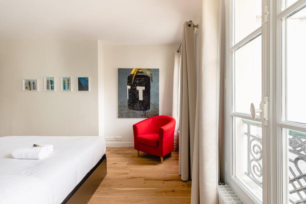 Łóżko lub łóżka w pokoju w obiekcie GuestReady - Estadia tranquila em Le Marais