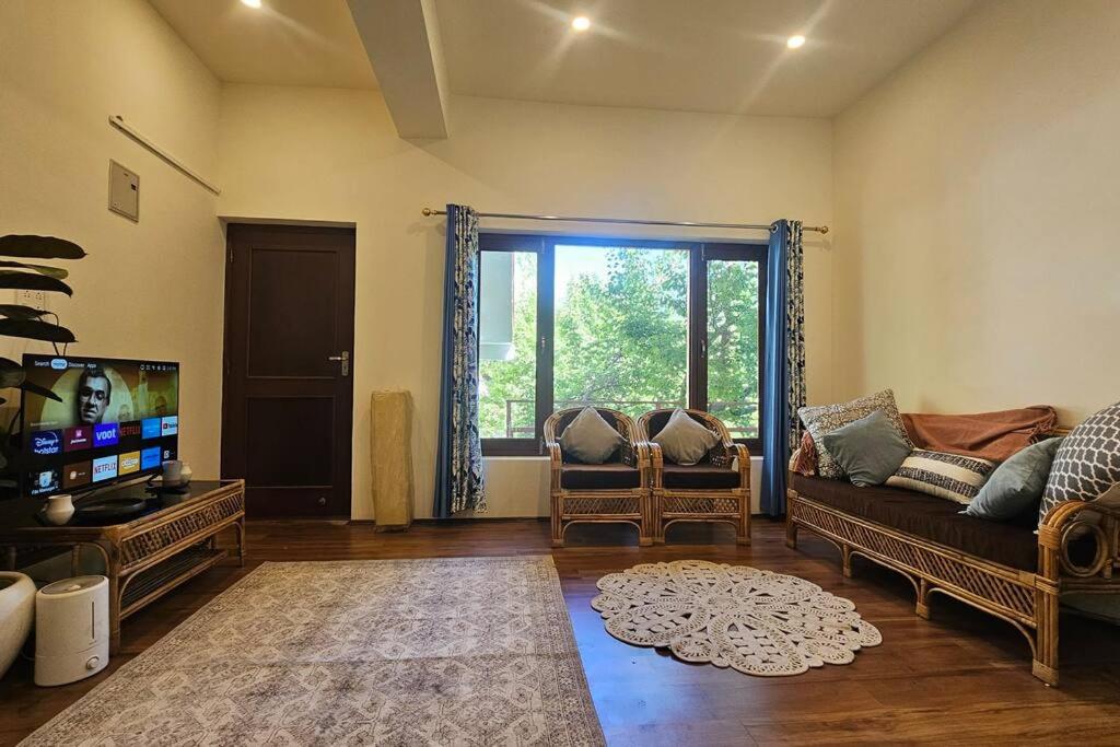 a living room with a couch and a tv at Paldan Orchids in Leh