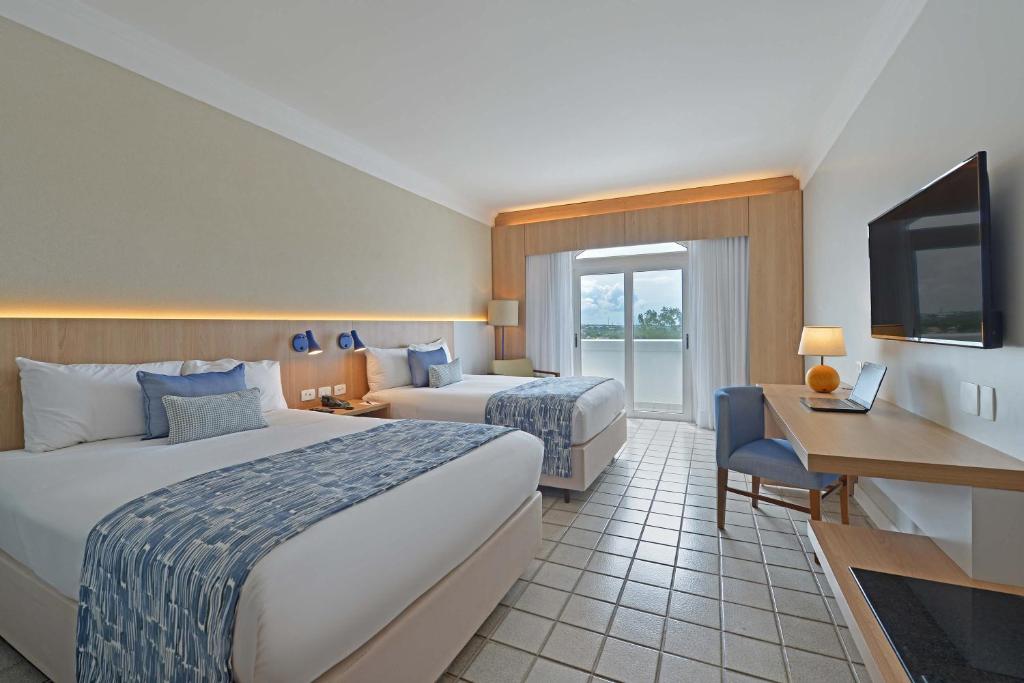 Postel nebo postele na pokoji v ubytování Hotel Deville Prime Salvador