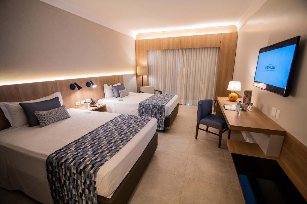 Postel nebo postele na pokoji v ubytování Hotel Deville Prime Salvador