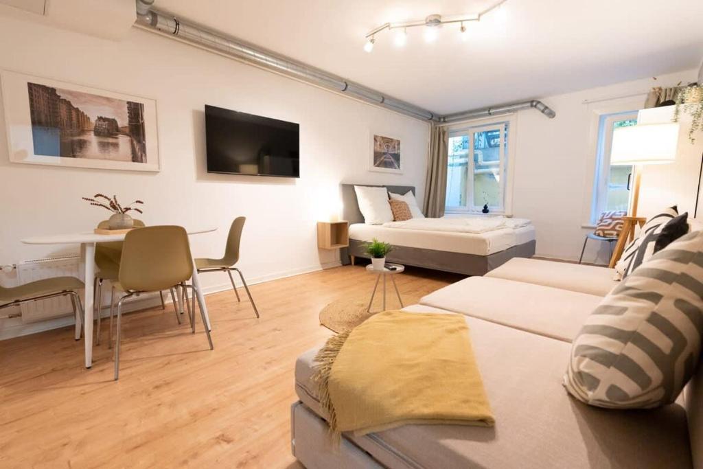 a living room with a bed and a dining room at Hamburg City Apartment for 5 in Hamburg