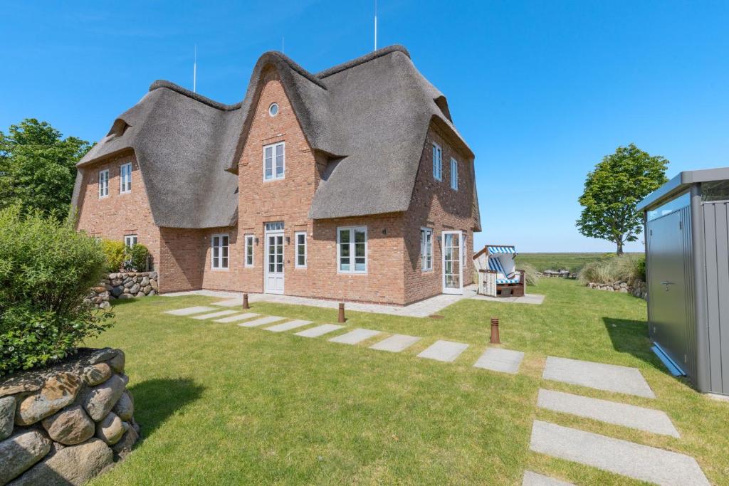 a large brick house with a gambrel roof at Westport in List
