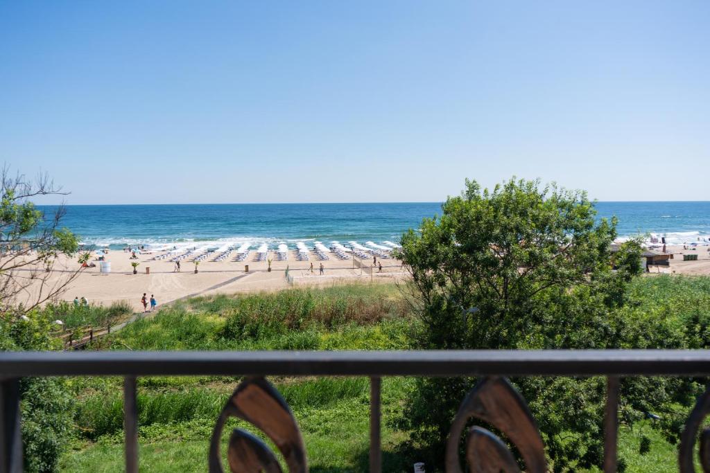 a view of a beach with umbrellas and the ocean at Dion Apartments in Lozenets