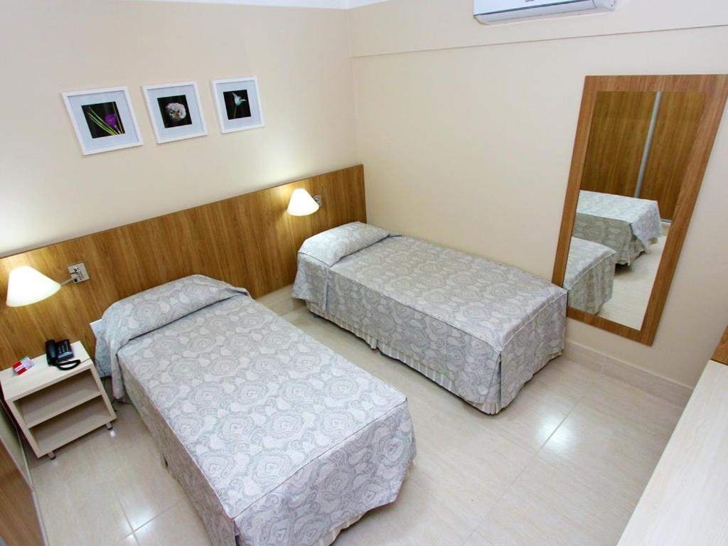 Cama ou camas em um quarto em Piazza diRoma Incluso o acesso ao Acqua park todos os dias, exceto no dia do check-out