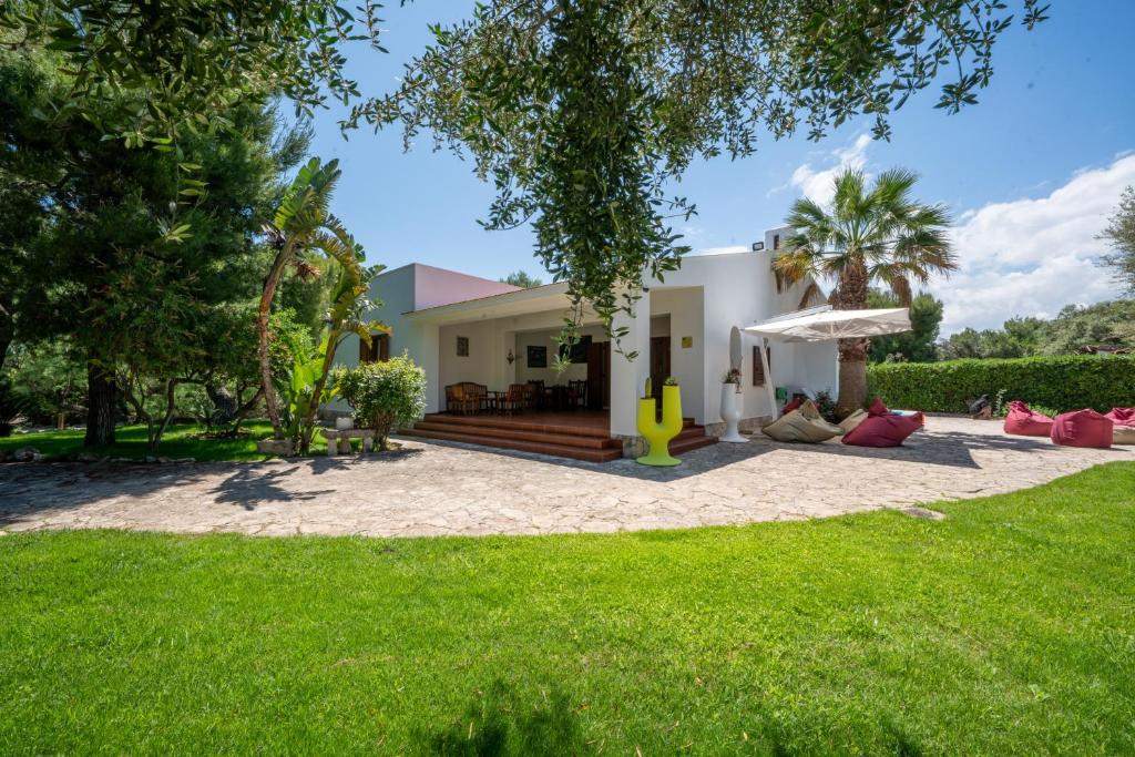 a house with a lawn in front of it at Villa Giglio with Garden and Mini Pool by Rentbeat in Rosa Marina