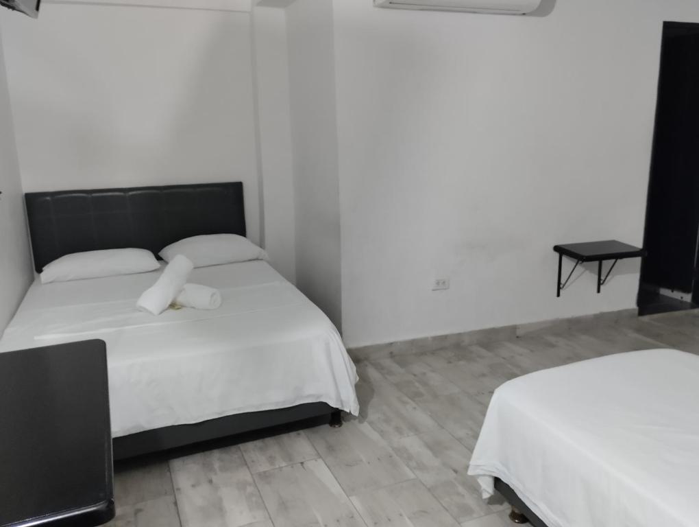 Postel nebo postele na pokoji v ubytování Hotel Ozzy