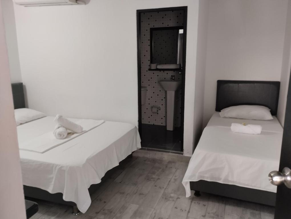Postel nebo postele na pokoji v ubytování Hotel Ozzy