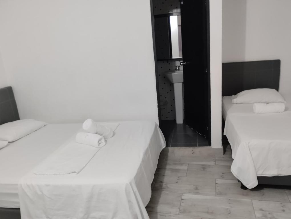 Postel nebo postele na pokoji v ubytování Hotel Ozzy