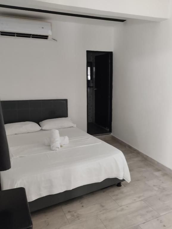 Postel nebo postele na pokoji v ubytování Hotel Ozzy