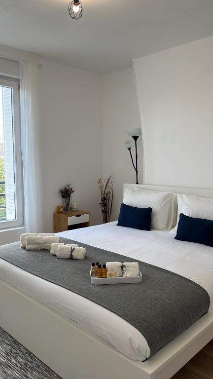 - un grand lit blanc avec un plateau de serviettes dans l'établissement 