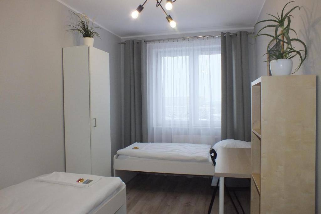 Posteľ alebo postele v izbe v ubytovaní Apartamenty Nila