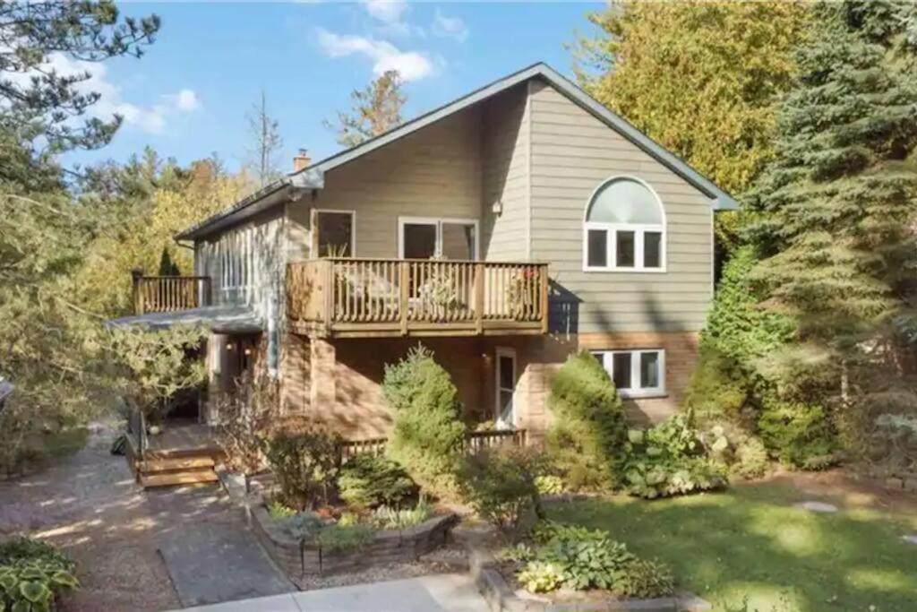 a large house with a deck and a yard at ReTreat yourself in Port Franks in Lambton Shores