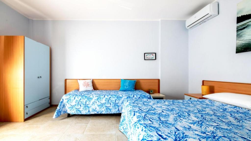 Postel nebo postele na pokoji v ubytování Riva Vieste Suites