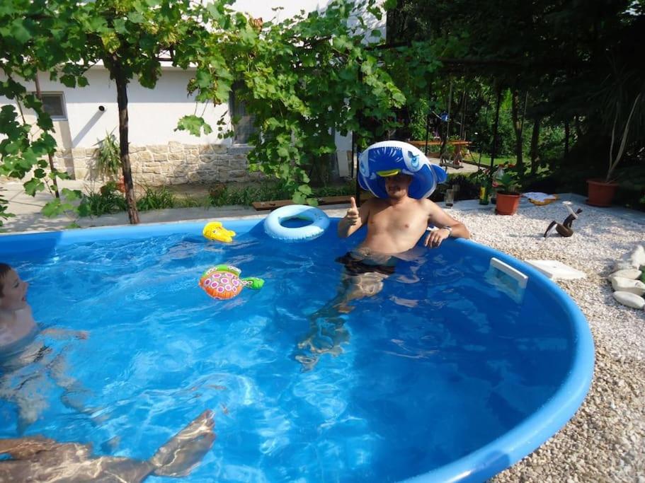 a young boy wearing a helmet in a swimming pool at Forest house in Varna City