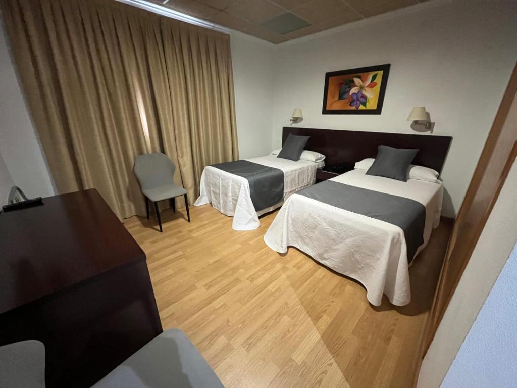 Postel nebo postele na pokoji v ubytování Hotel Constitución
