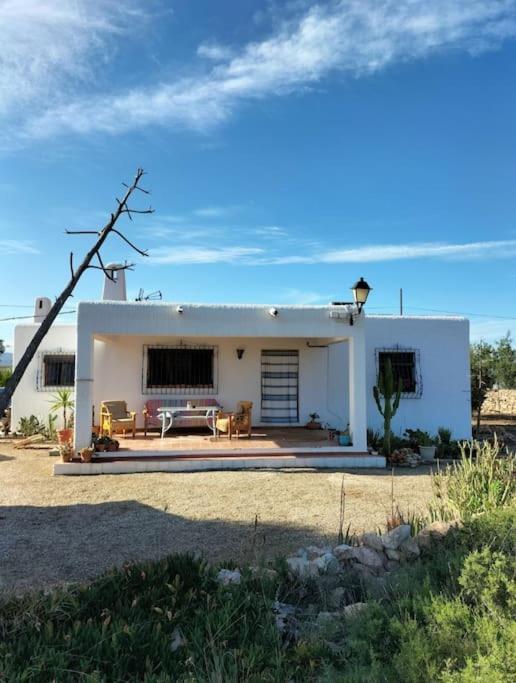 a white house with a patio in front of it at Cortijo El Ventorrillo de Agua Amarga in Almería