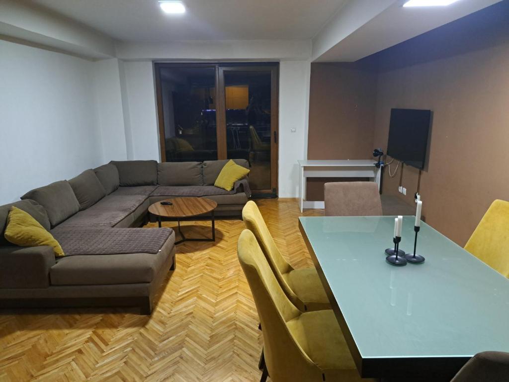 a living room with a couch and a table at Nena Apartment in Kumanovo