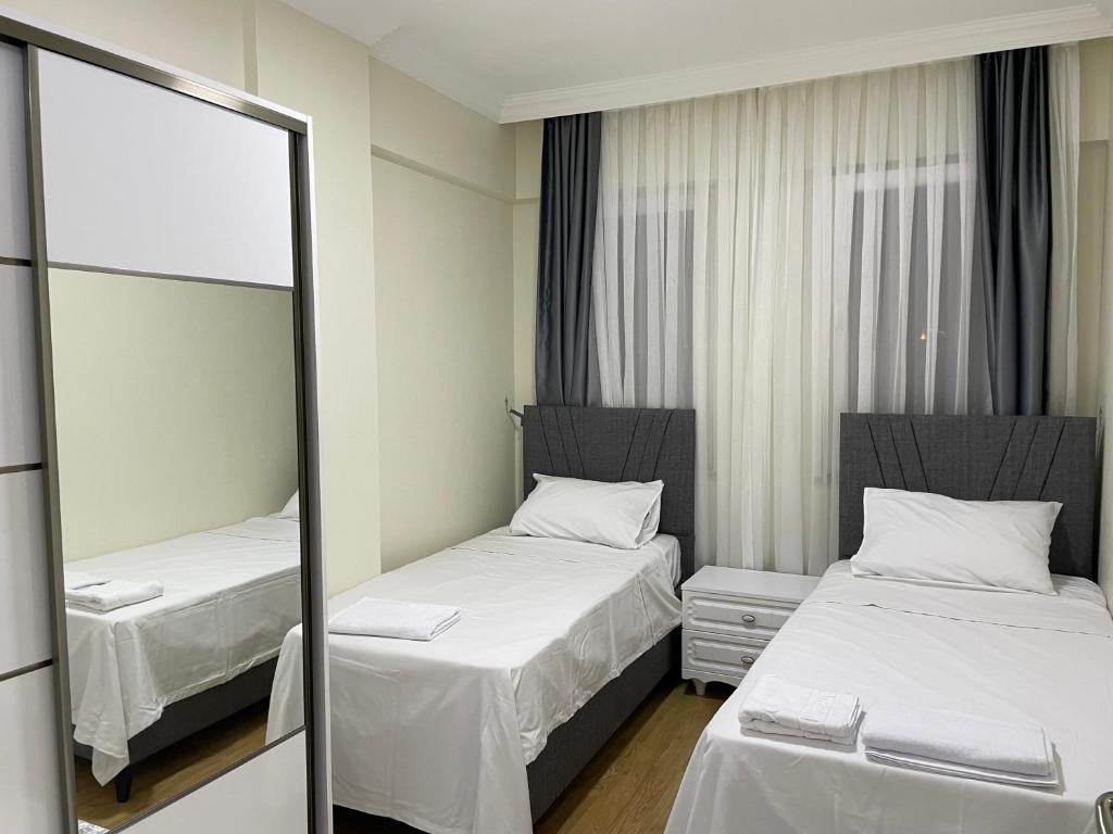 Postel nebo postele na pokoji v ubytování Köseoğlu APART