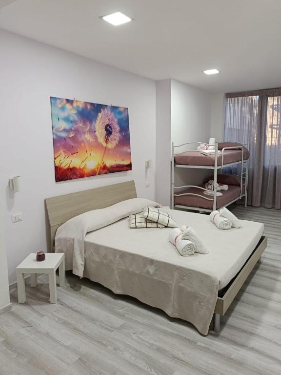 a bedroom with a bed and a painting on the wall at B&B PalmaViola in Caserta
