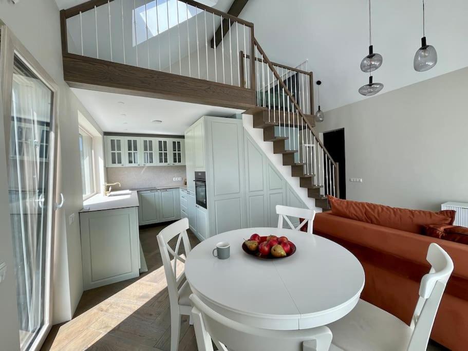 a white table and chairs in a living room at Seaside Serenity Retreat in Palanga