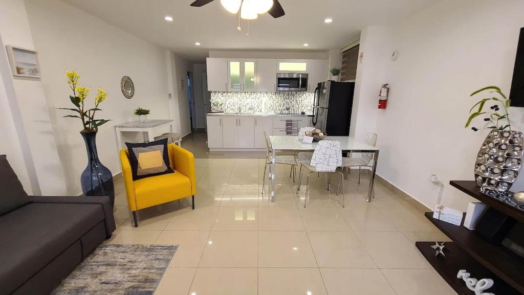 a living room with a couch and a table and chairs at Charming & Family-Friendly Boqueron Village Condos! in Boqueron