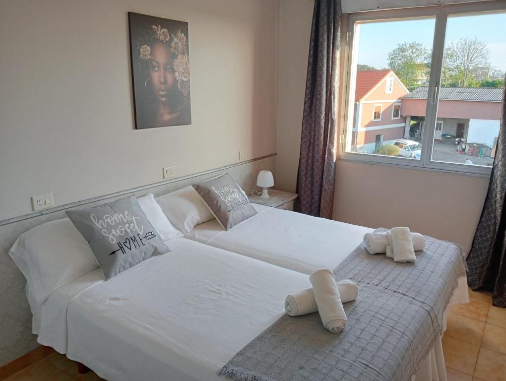 Postel nebo postele na pokoji v ubytování CASA PORTELA APARTAMENTOS