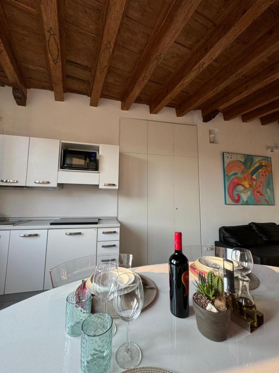 a kitchen with a table with wine glasses on it at Casa sulle mura Romane - Old town in Bergamo