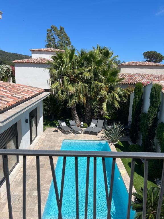 a view from the balcony of a villa with a swimming pool at Superbe villa golfe st Tropez in Sainte-Maxime