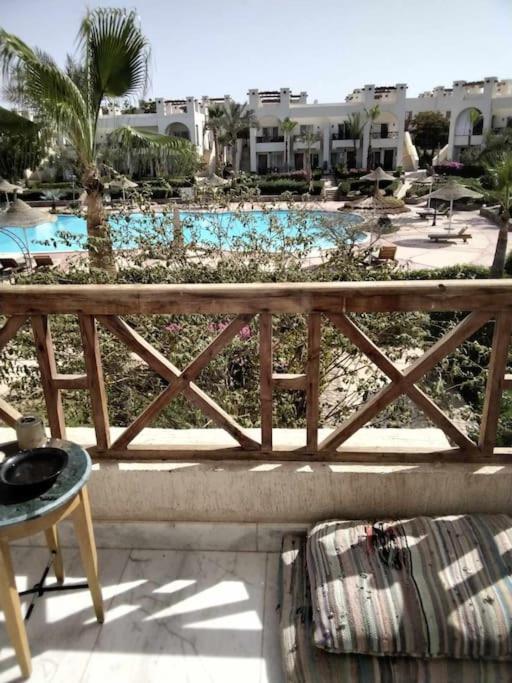 a view of a pool from the balcony of a resort at Sunny Lakes beautiful flat for relax in Sharm El Sheikh