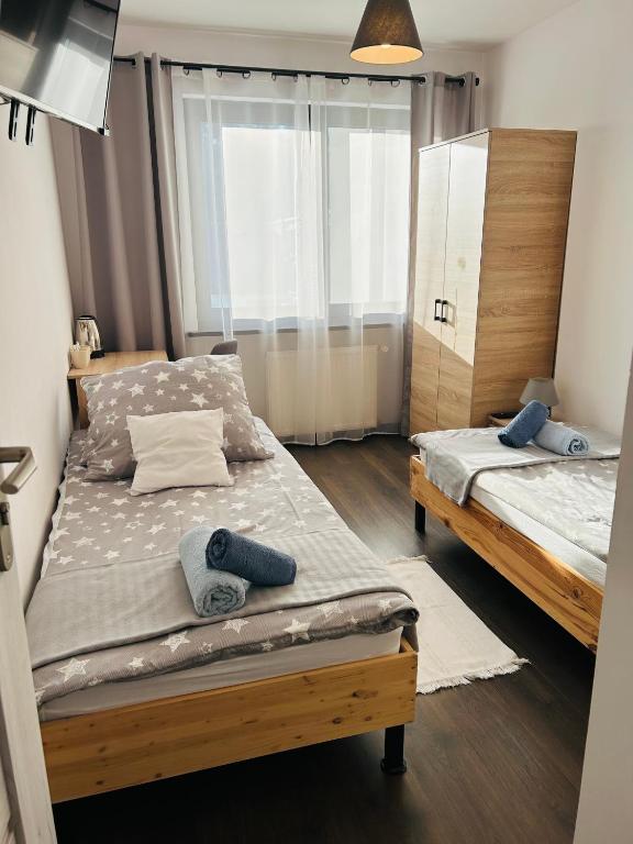 Postel nebo postele na pokoji v ubytování Noclegi na Turystycznej-noclegi w sercu uzdrowiska