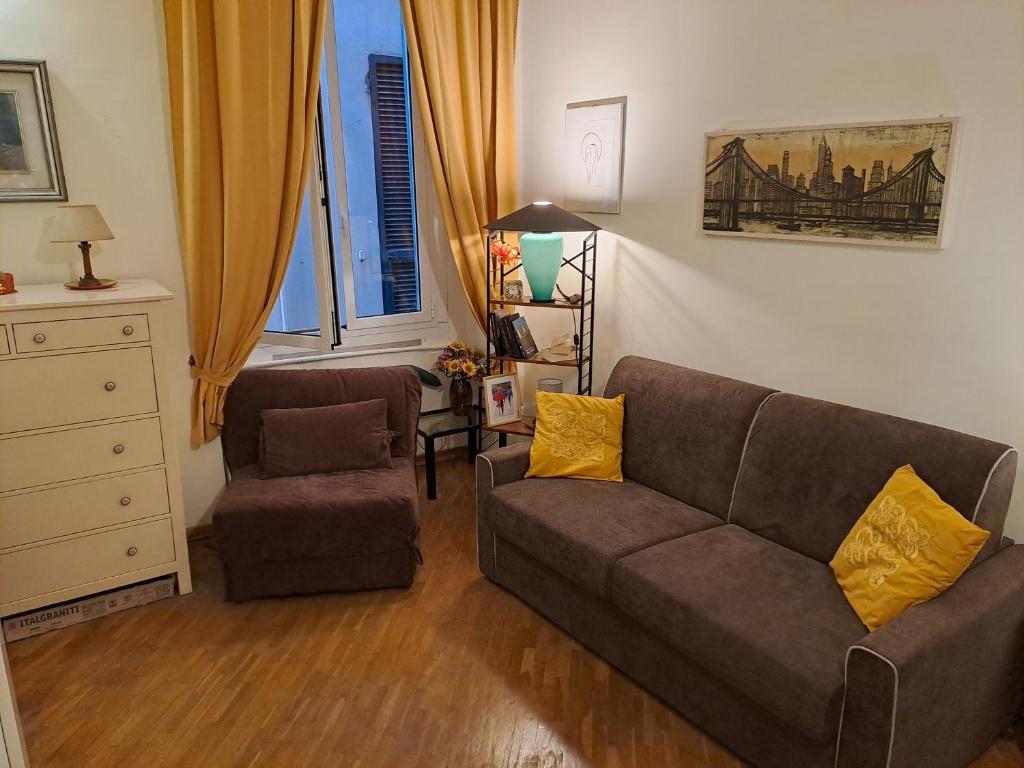 a living room with a couch and a chair at OASI San Lorenzo in Genova