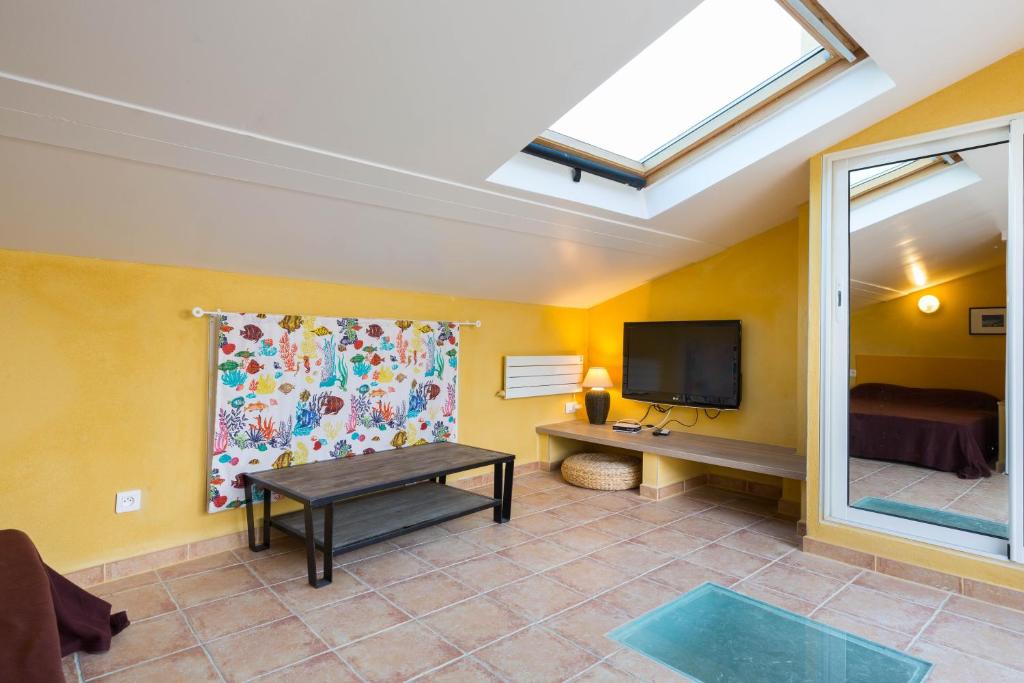 a living room with a skylight and a tv at World Hostel -la girelle-Condo Rooftop Veranda Terrace in Marseille