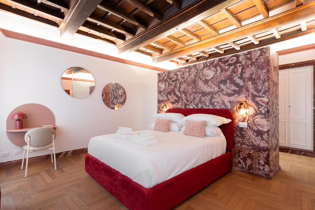 a bedroom with a large bed with a red headboard at My Trevi Suite & Apartment in Rome
