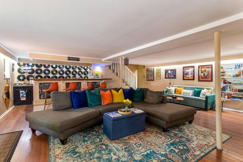 a large living room with a couch and a table at Honky Tonk Home Bar, Minutes to Airport & Broadway in Nashville