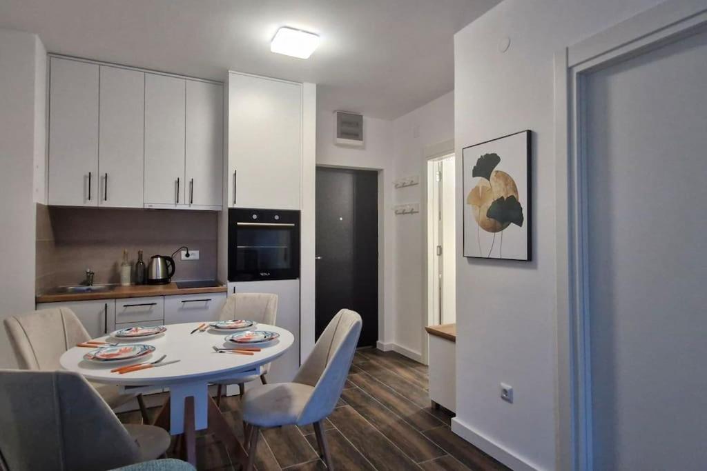 a kitchen and a table and chairs in a room at Zira2 in Kotor