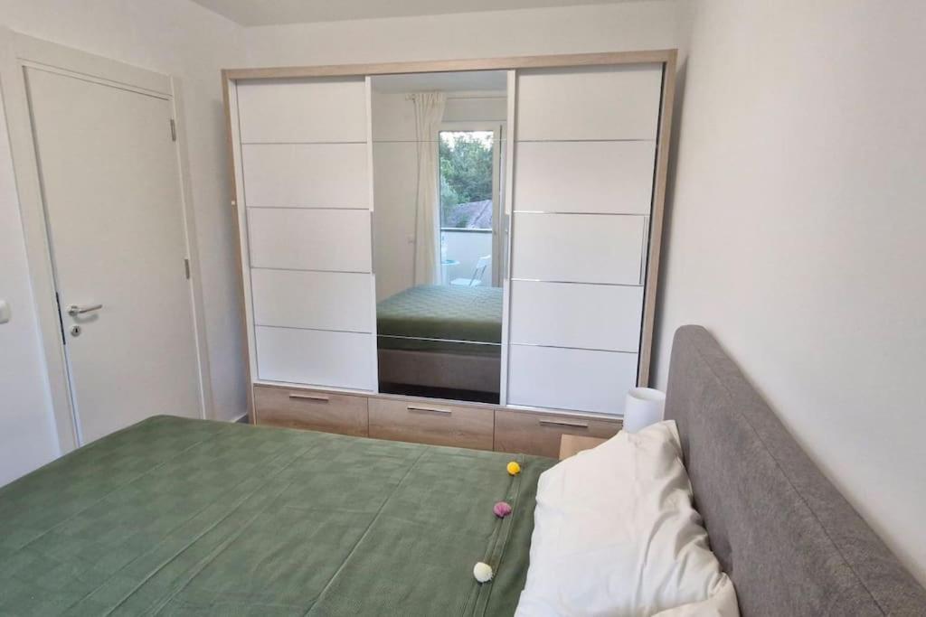a bedroom with a bed and a large mirror at Zira2 in Kotor