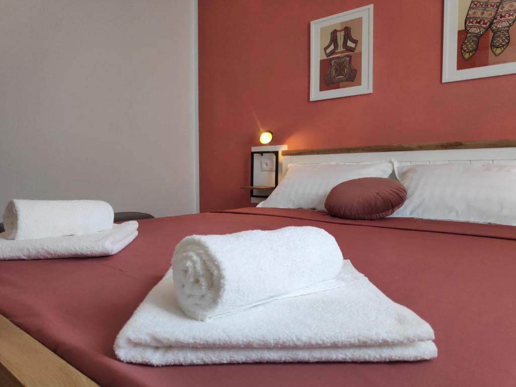 a bedroom with two beds with towels on them at Te Amantia Apartment in Tirana