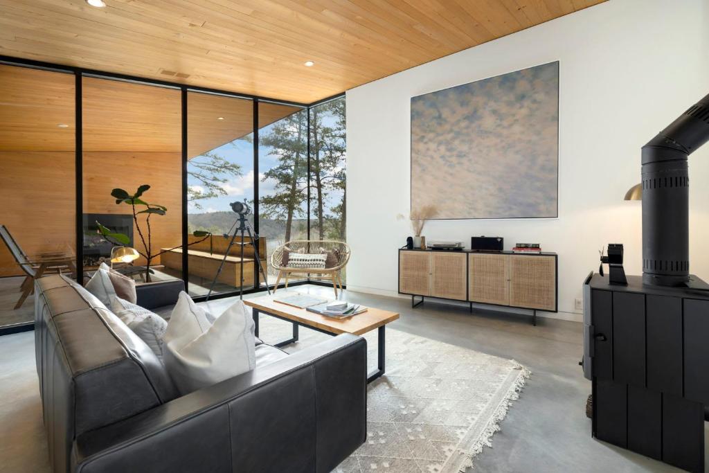 a living room with a couch and a table at Tanglewood Cabin-Lake Access-Private-Modern in Rambo Riviera