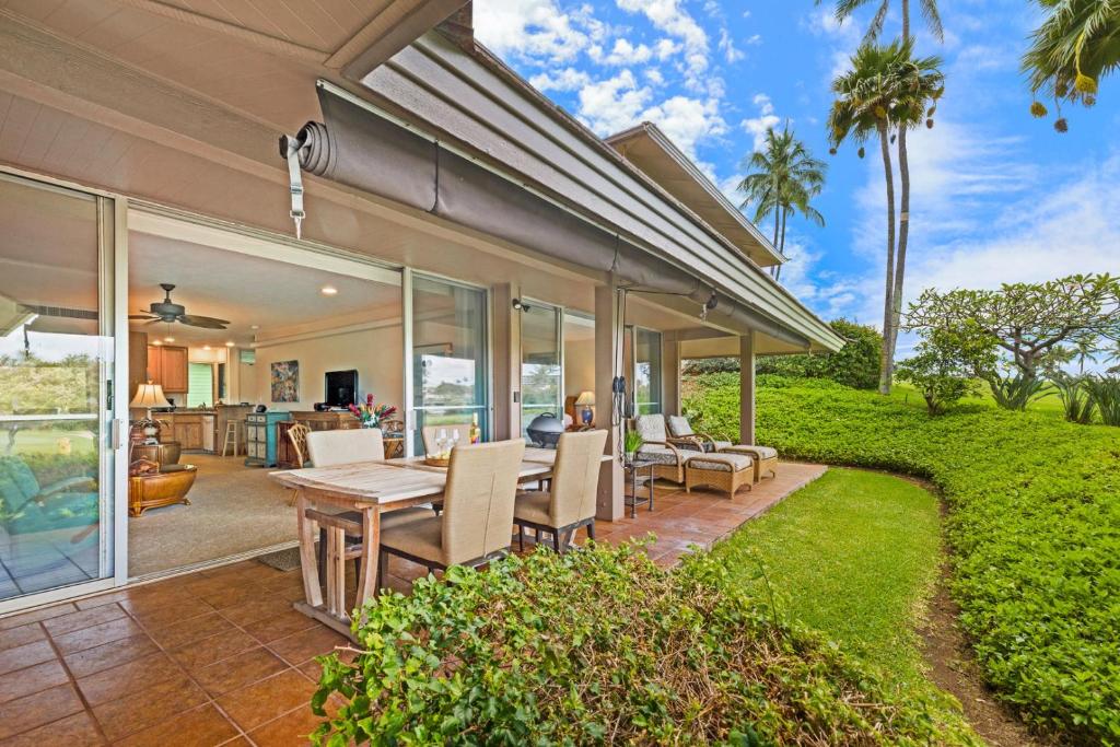 a home with a patio with a table and chairs at Maui Eldorado - G108 - Stay in the Heart of Kaanapali in Kahana