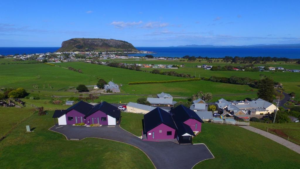 an aerial view of a village with houses and the ocean at Horizon Deluxe Apartments in Stanley