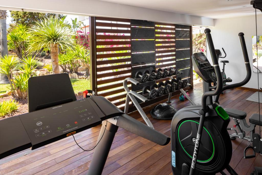 a room with a gym with a treadmill at Hotel Boutique Ses Pitreras in San Antonio Bay