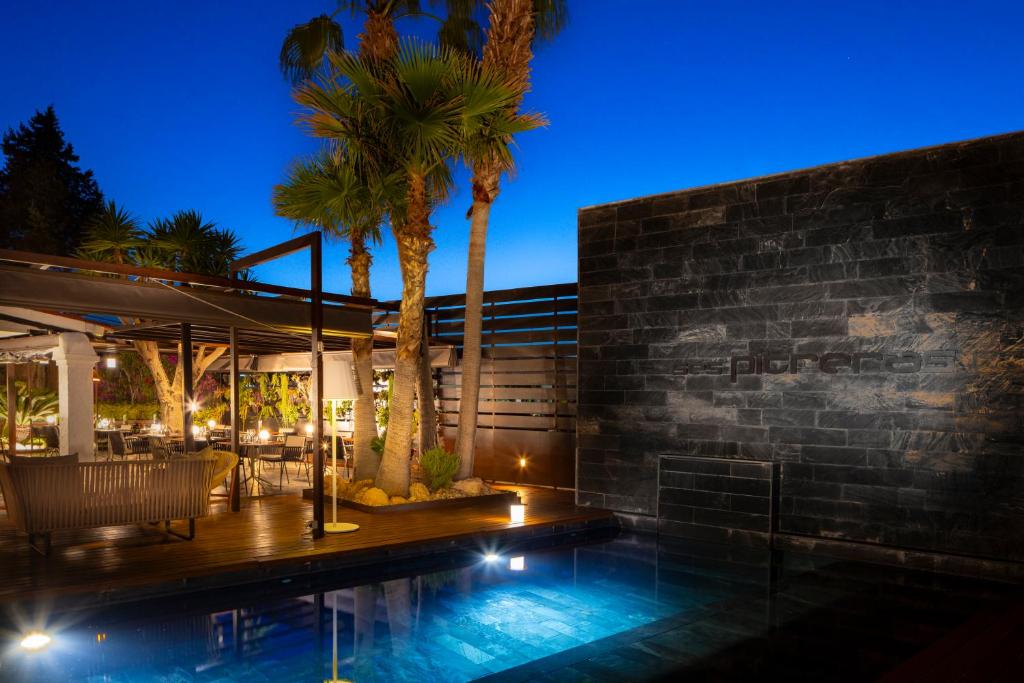 a house with a swimming pool at night at Hotel Boutique Ses Pitreras in San Antonio Bay