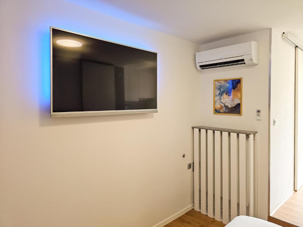 a living room with a flat screen tv on the wall at TOP - Ljubljana's Central Gem - free public parking in Ljubljana
