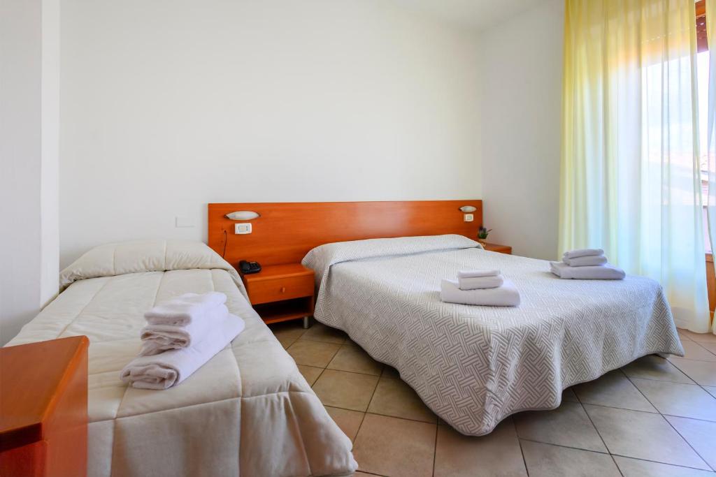 Postel nebo postele na pokoji v ubytování Hotel Vico Alto Siena