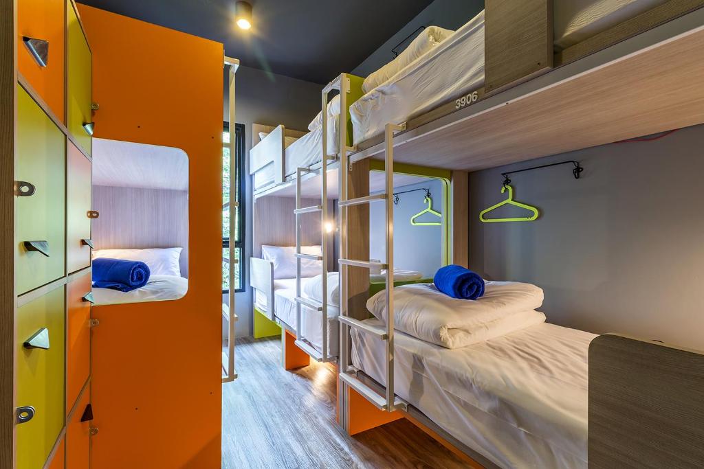 a bunk bed room with two bunk beds at iSanook Hostel in Bangkok