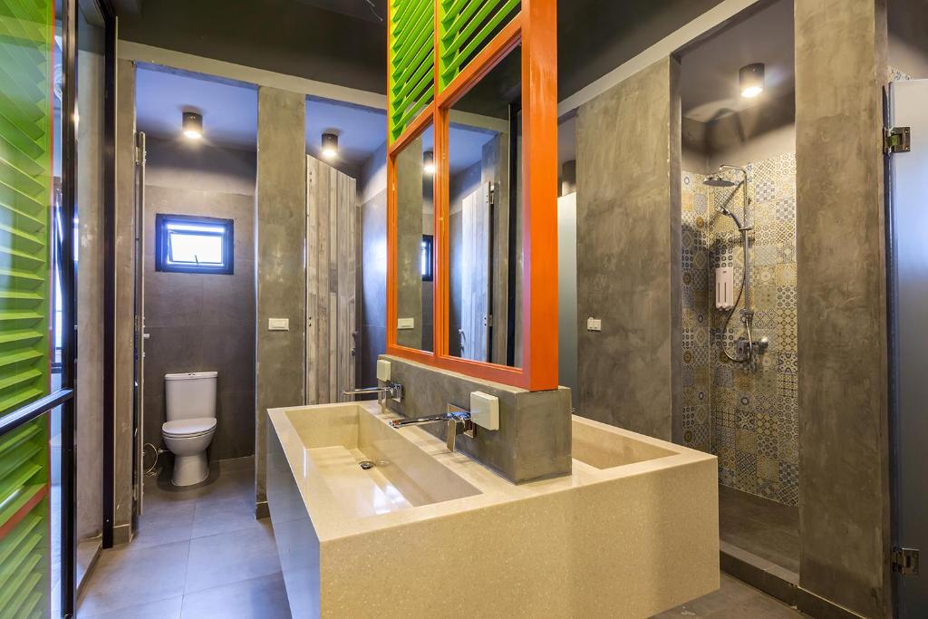 a bathroom with a sink and a toilet at iSanook Hostel in Bangkok