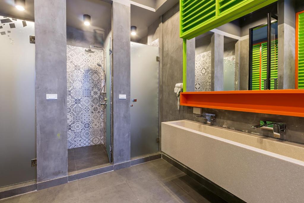 a bathroom with a shower and a sink at iSanook Hostel in Bangkok