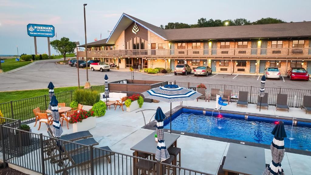 a hotel with a pool in front of a building at PINEMARK Inn Suites Events in Saint Clair